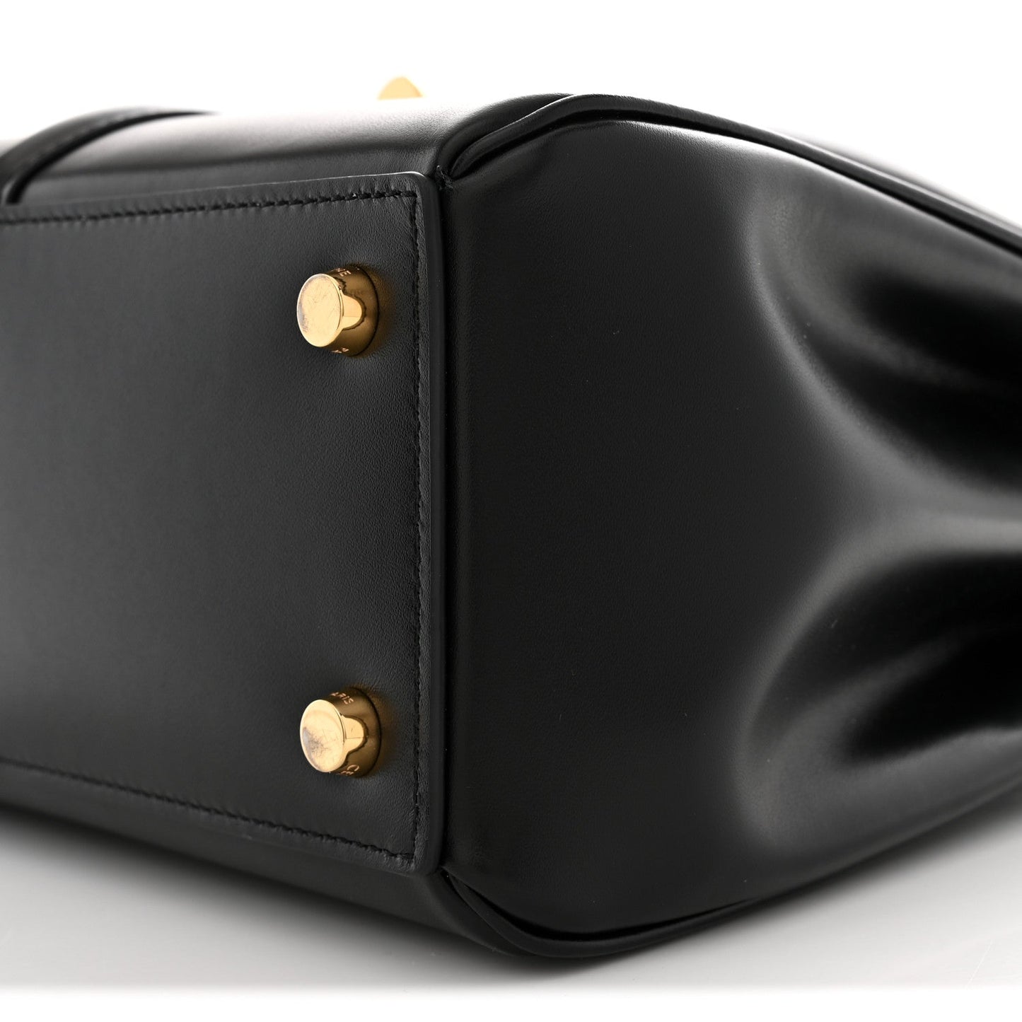 Black leather corner with two gold snap studs and smooth satin finish
