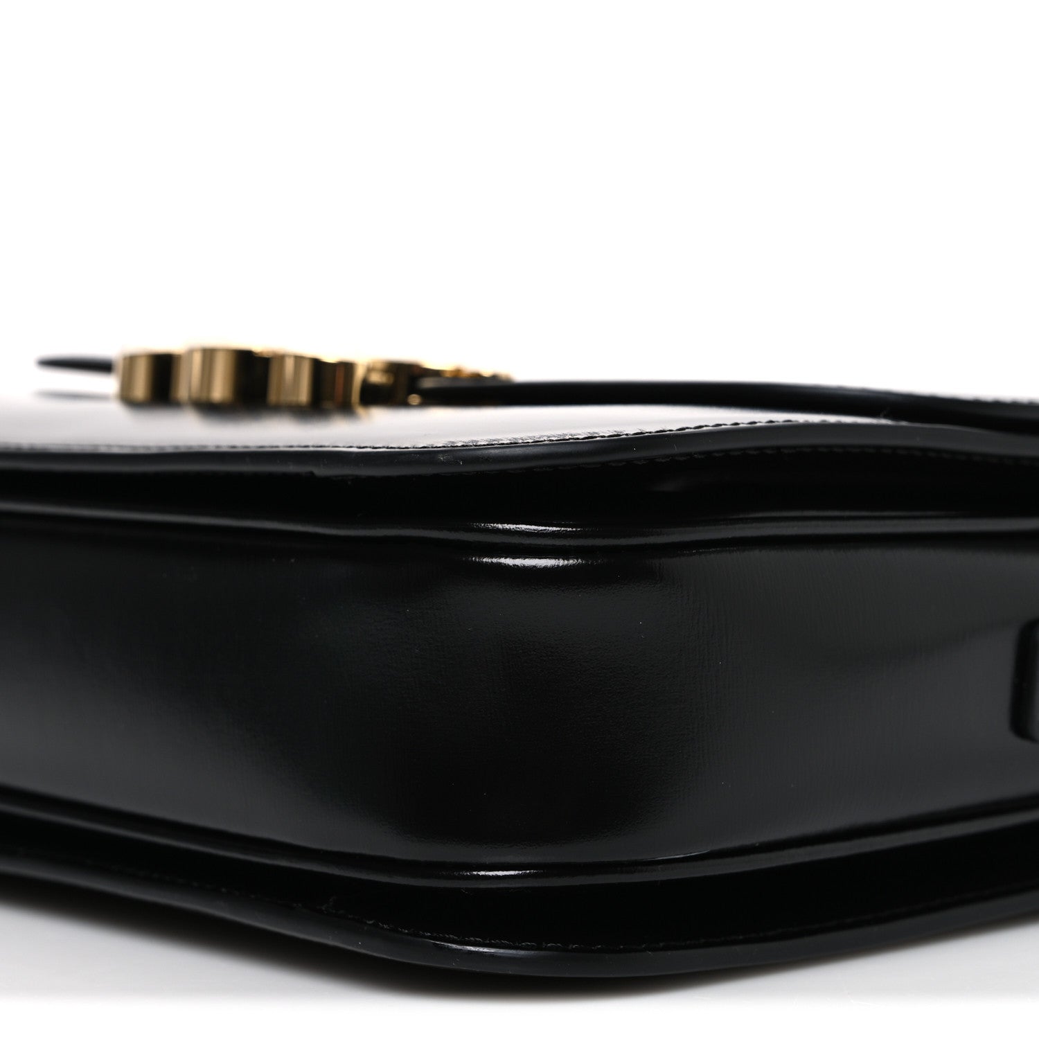 Shiny calfskin medium shoulder bag bottom corner close-up with gold-tone hardware