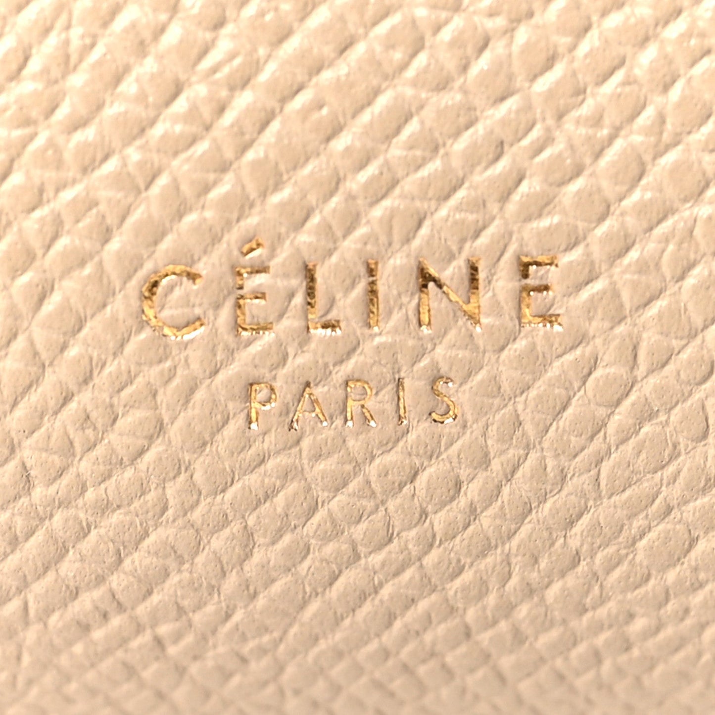 Celine stamp logo on light taupe grained leather, close-up