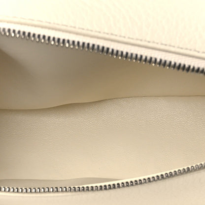 Pouch interior view showing zipper track, smooth lining, and grained leather edge