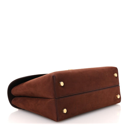 Chestnut brown leather satchel with gold feet and folded flap front.