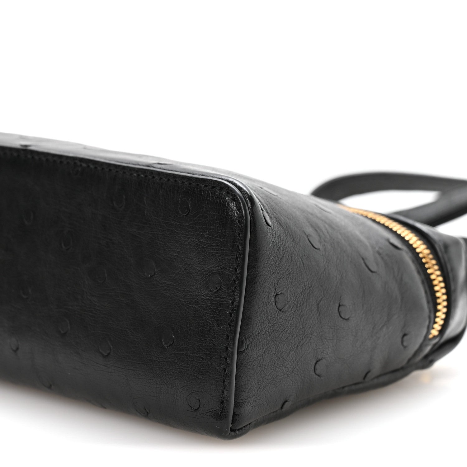 Black ostrich pocket pouch side close-up with textured finish and gold zipper trim