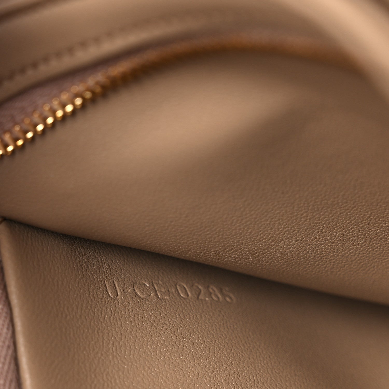 Close-up of embossed leather stamp on the bag interior