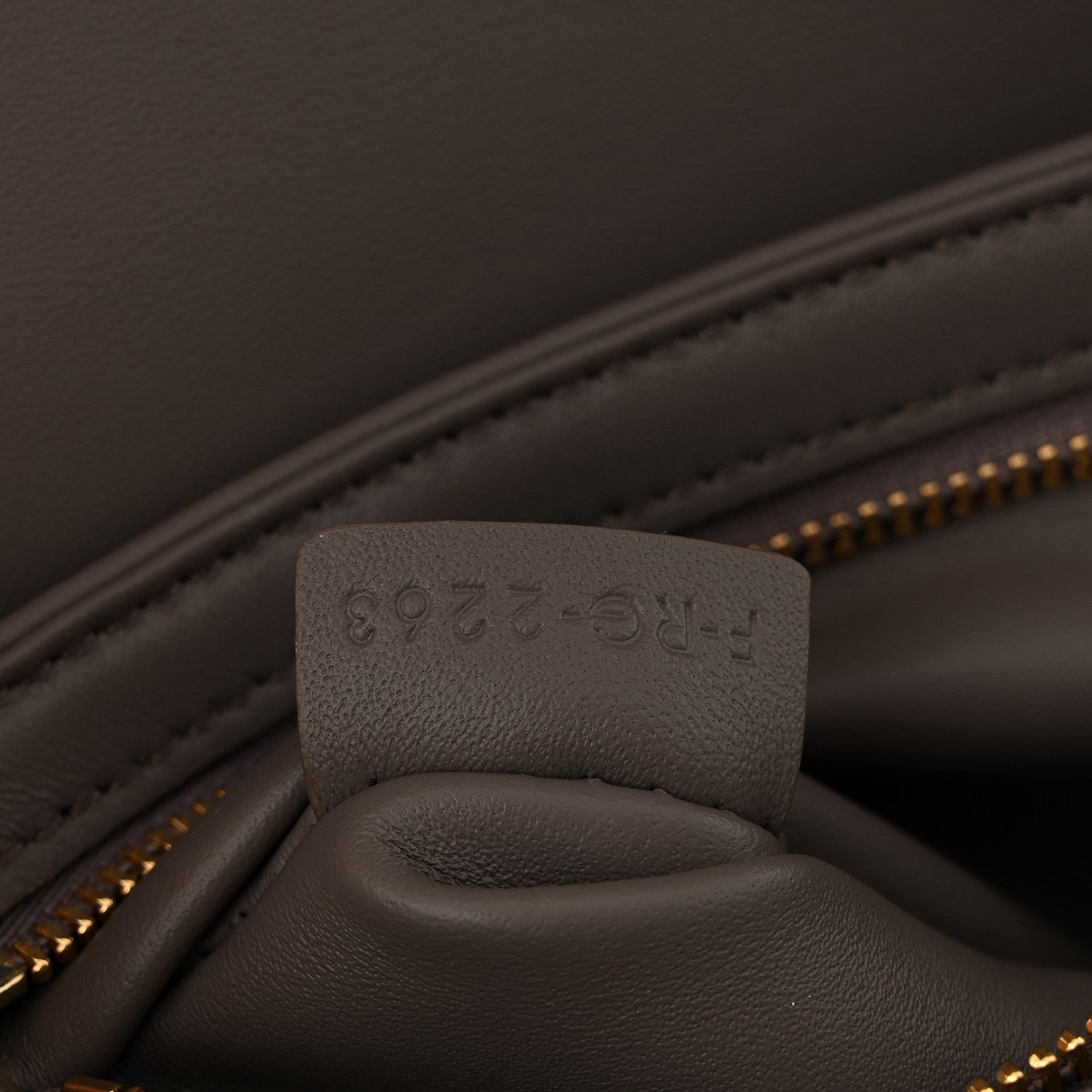 Close-up of interior pocket and stamped leather tab inside Celine bag