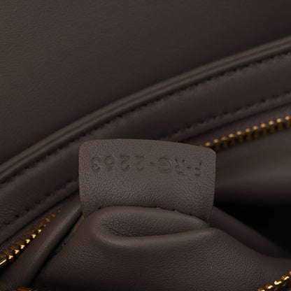 Close-up of interior pocket and stamped leather tab inside Celine bag