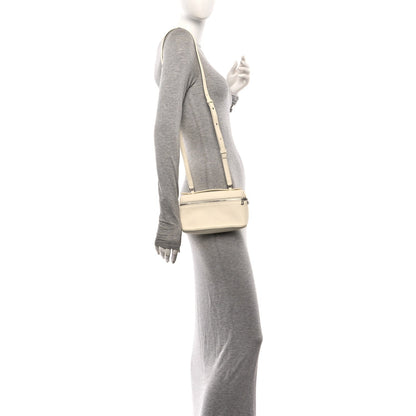 Loro Piana grained calfskin pouch in white, worn crossbody with top zip