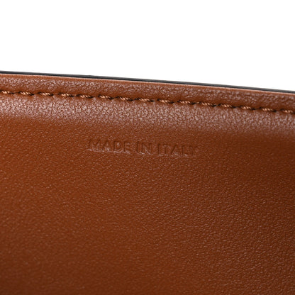 Tan leather edge with “MADE IN ITALY” stamped text and stitched border.