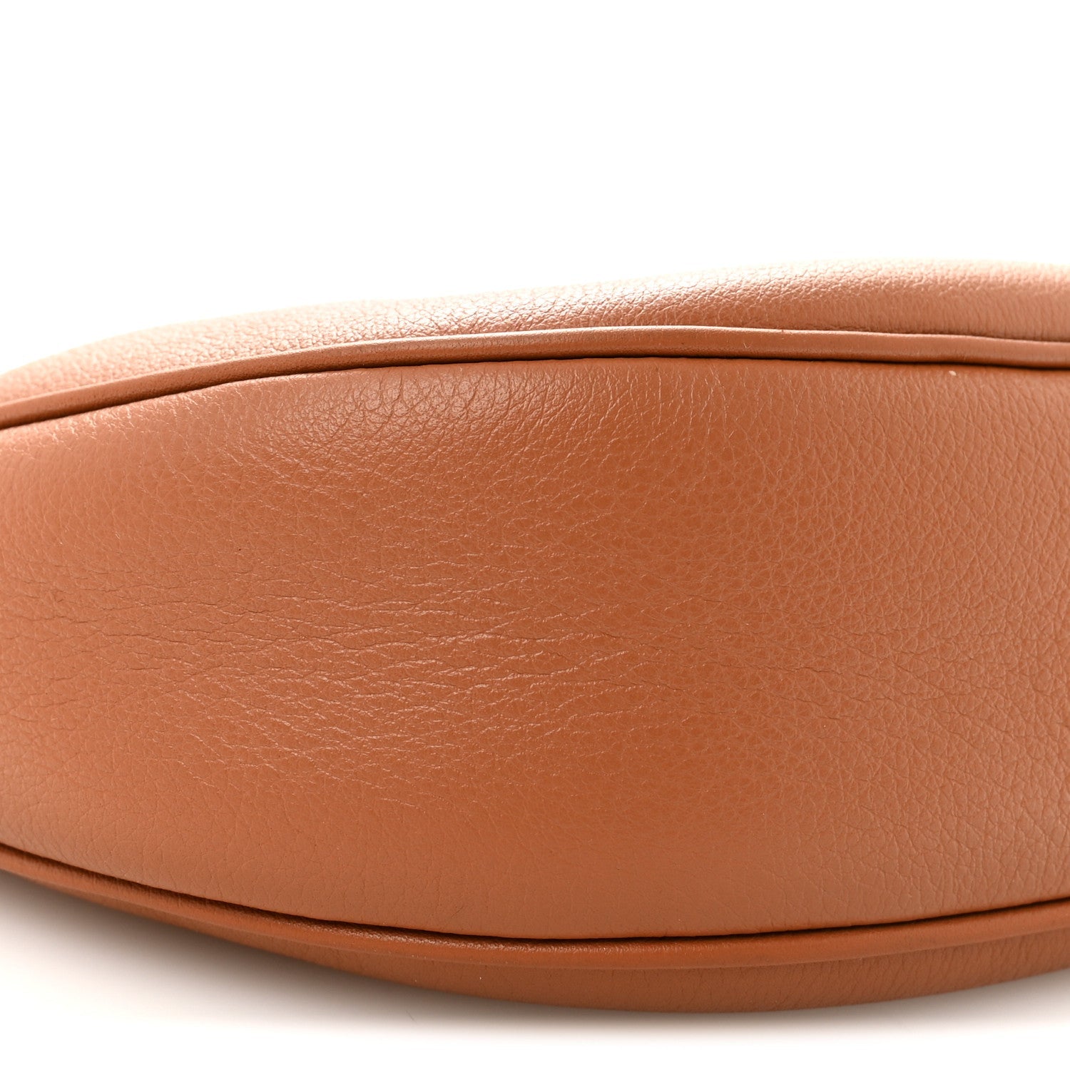 Tan leather hobo bag front panel close-up with smooth grain and curved seam