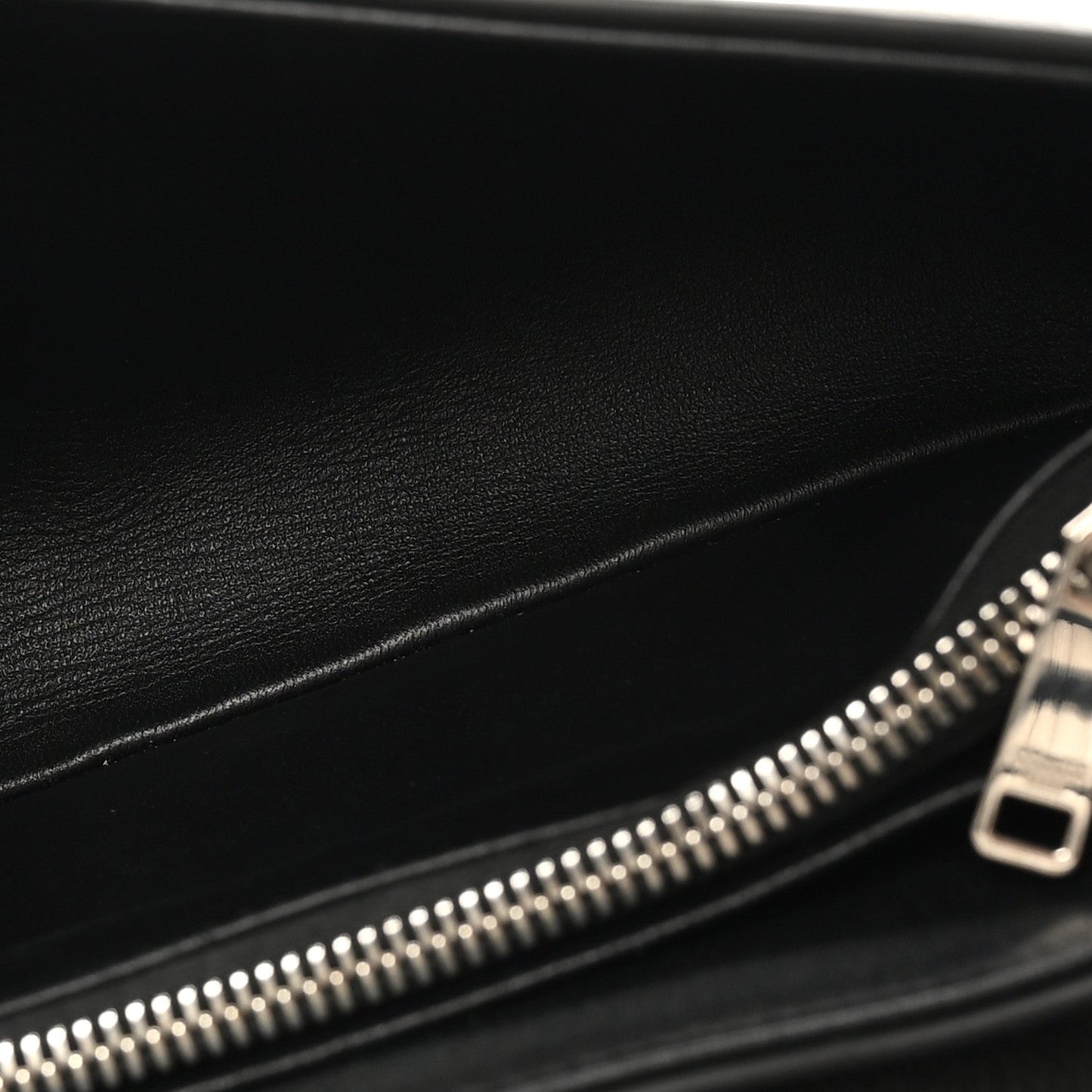 Black leather bag interior with silver zipper and metal zipper pull