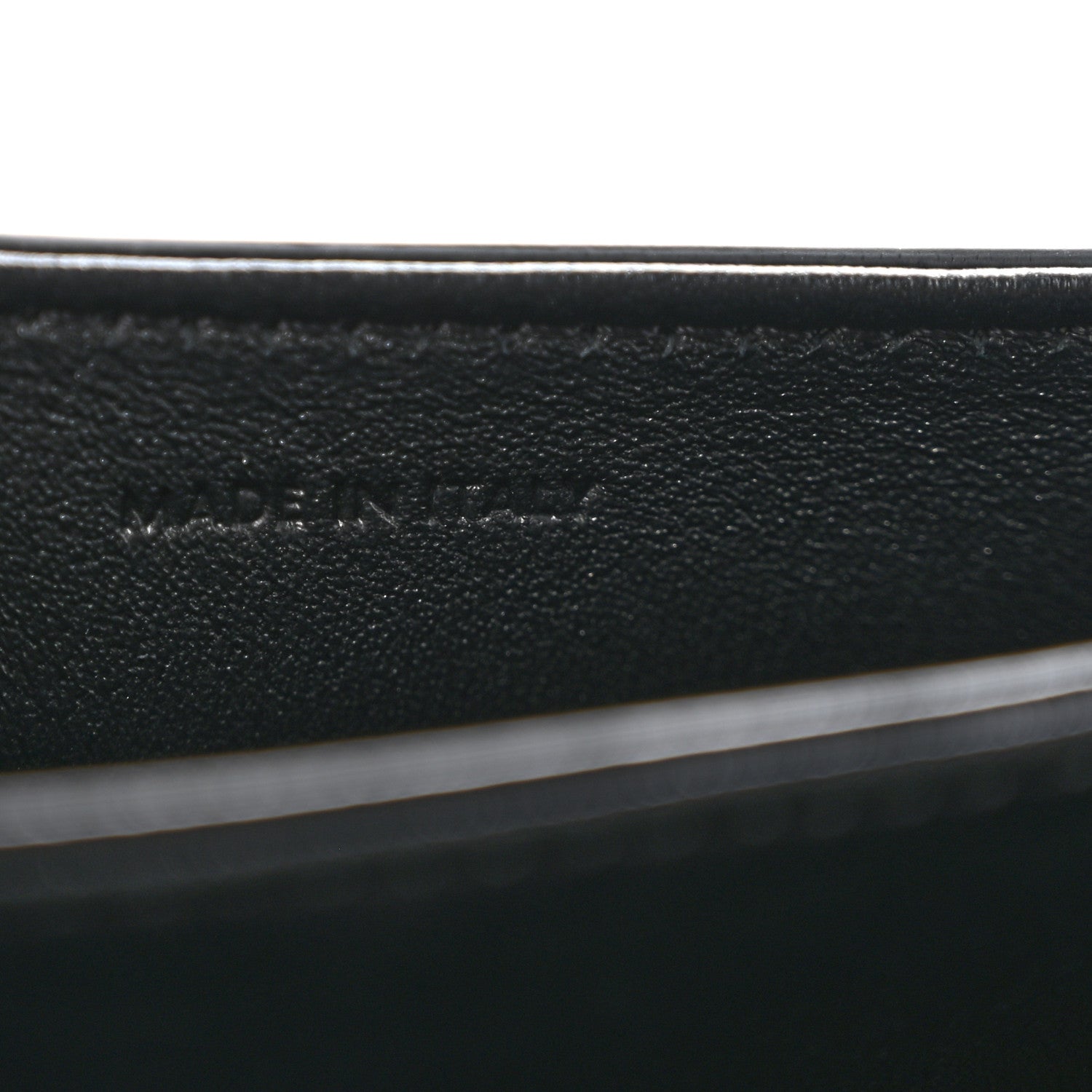 Black leather mini crossbody bag, close-up of interior label text