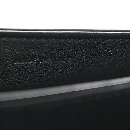 Black leather mini crossbody bag, close-up of interior label text