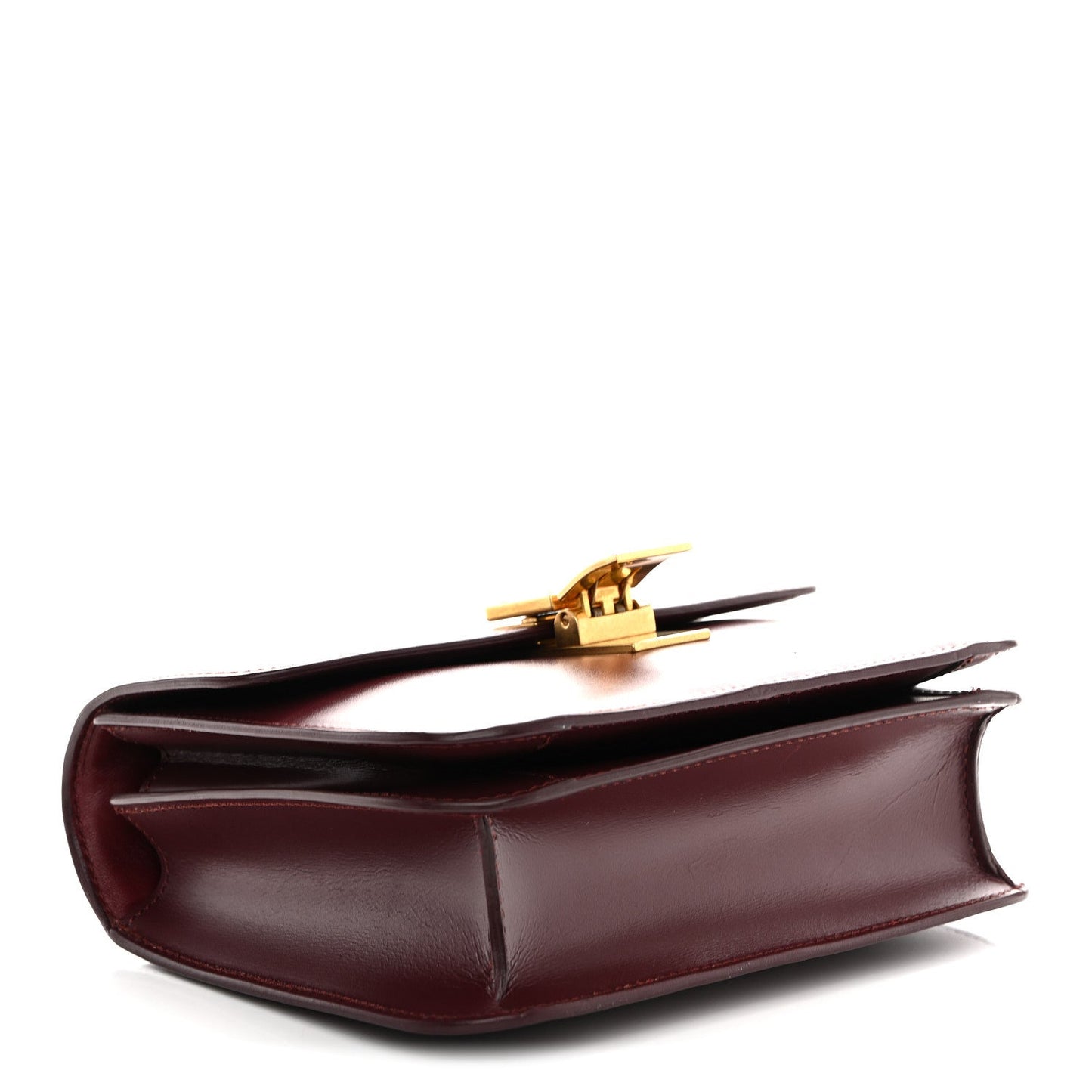 Burgundy leather bag base with fold detail and gold-tone front clasp on top edge.