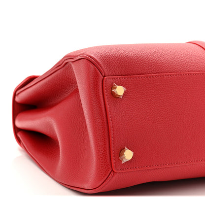 Red leather bag corner with gold studs and folded opening