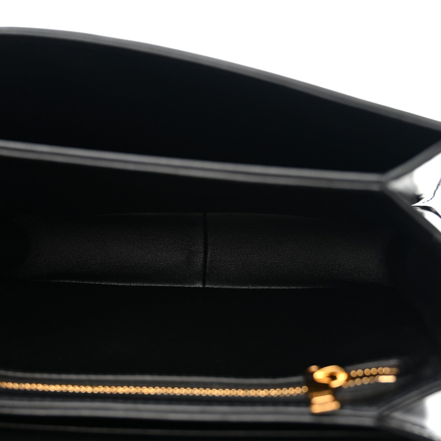 Black leather crossbody bag interior view with gold zipper pull and logo detail.
