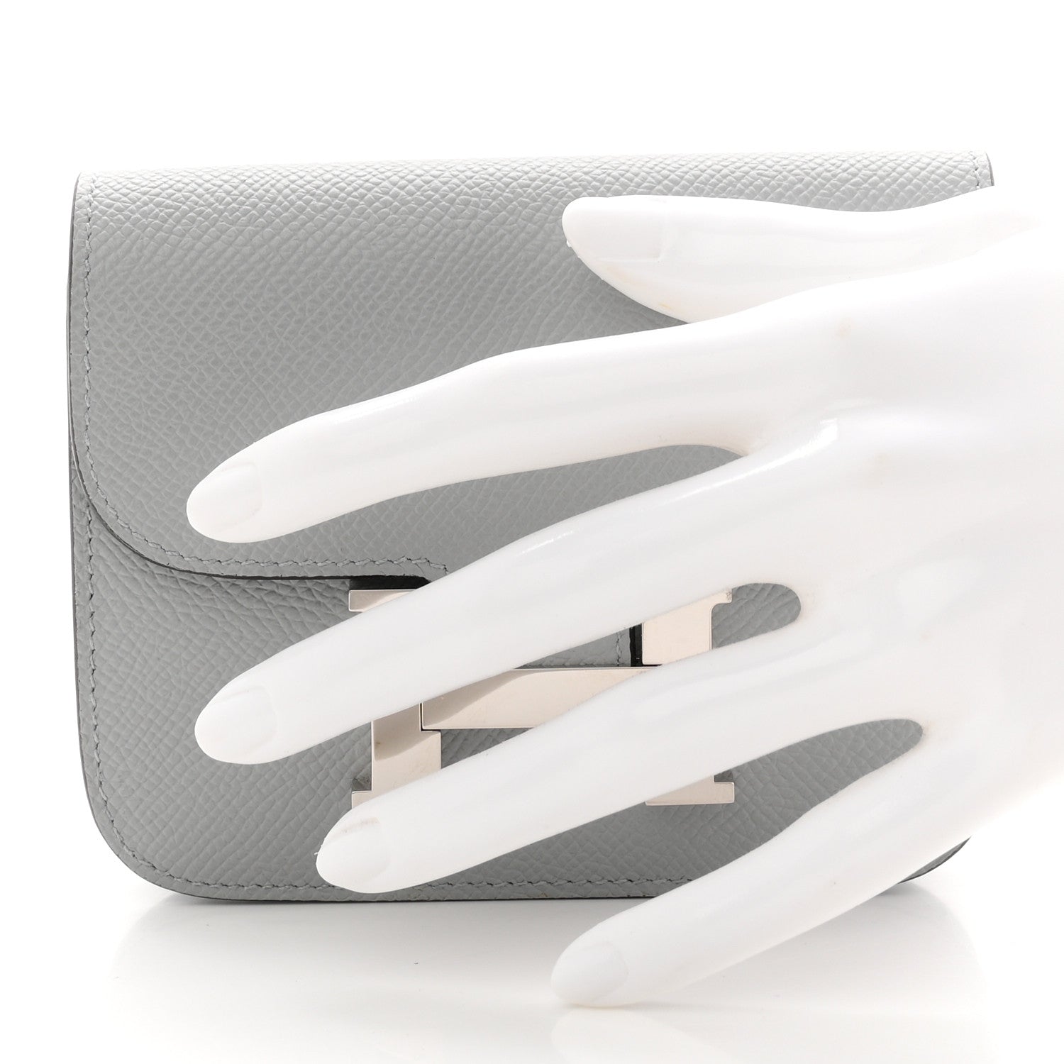 Hermes Constance slim wallet, light blue textured leather, open flap with H clasp.