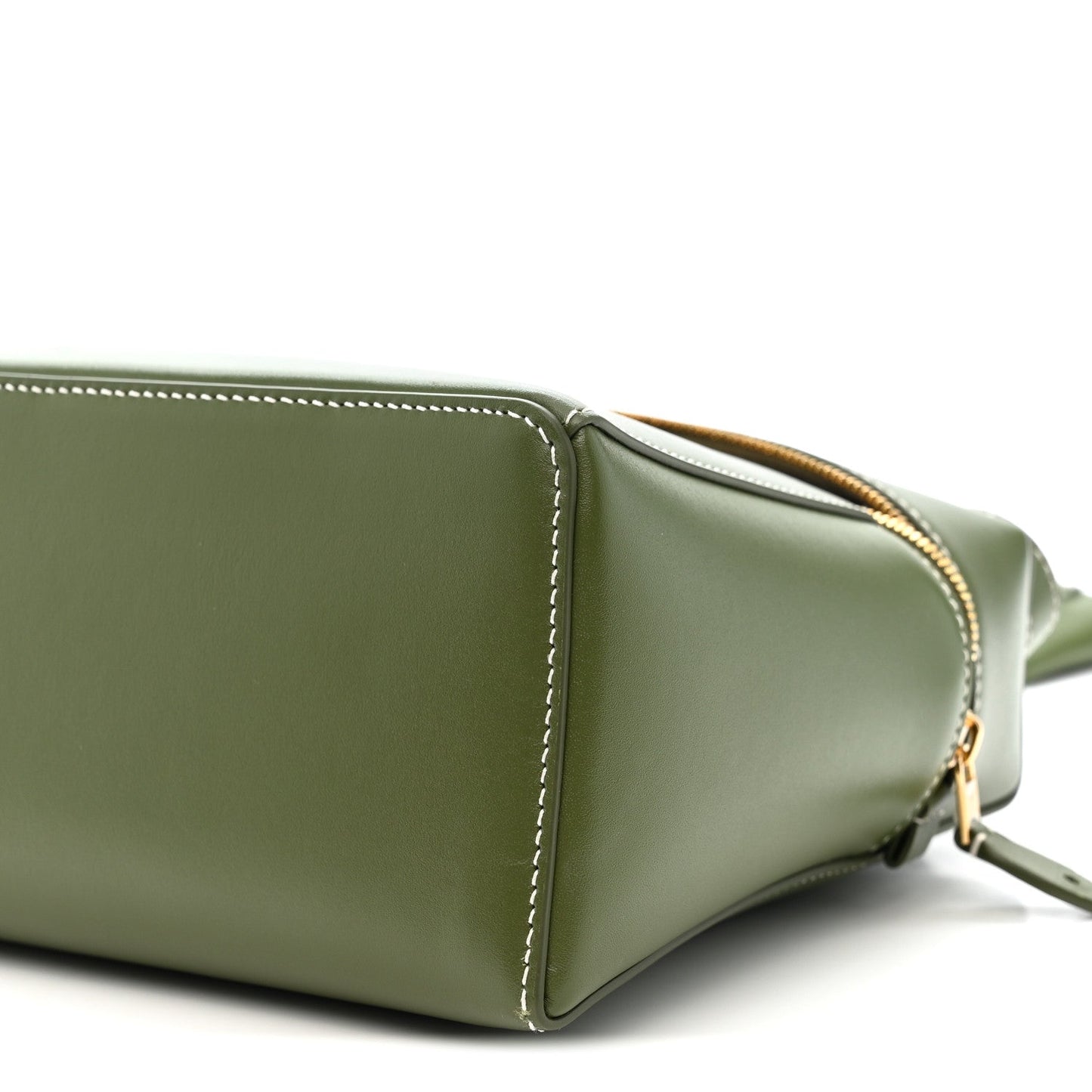 Olive green leather handbag corner detail with gold zipper trim and strap hardware