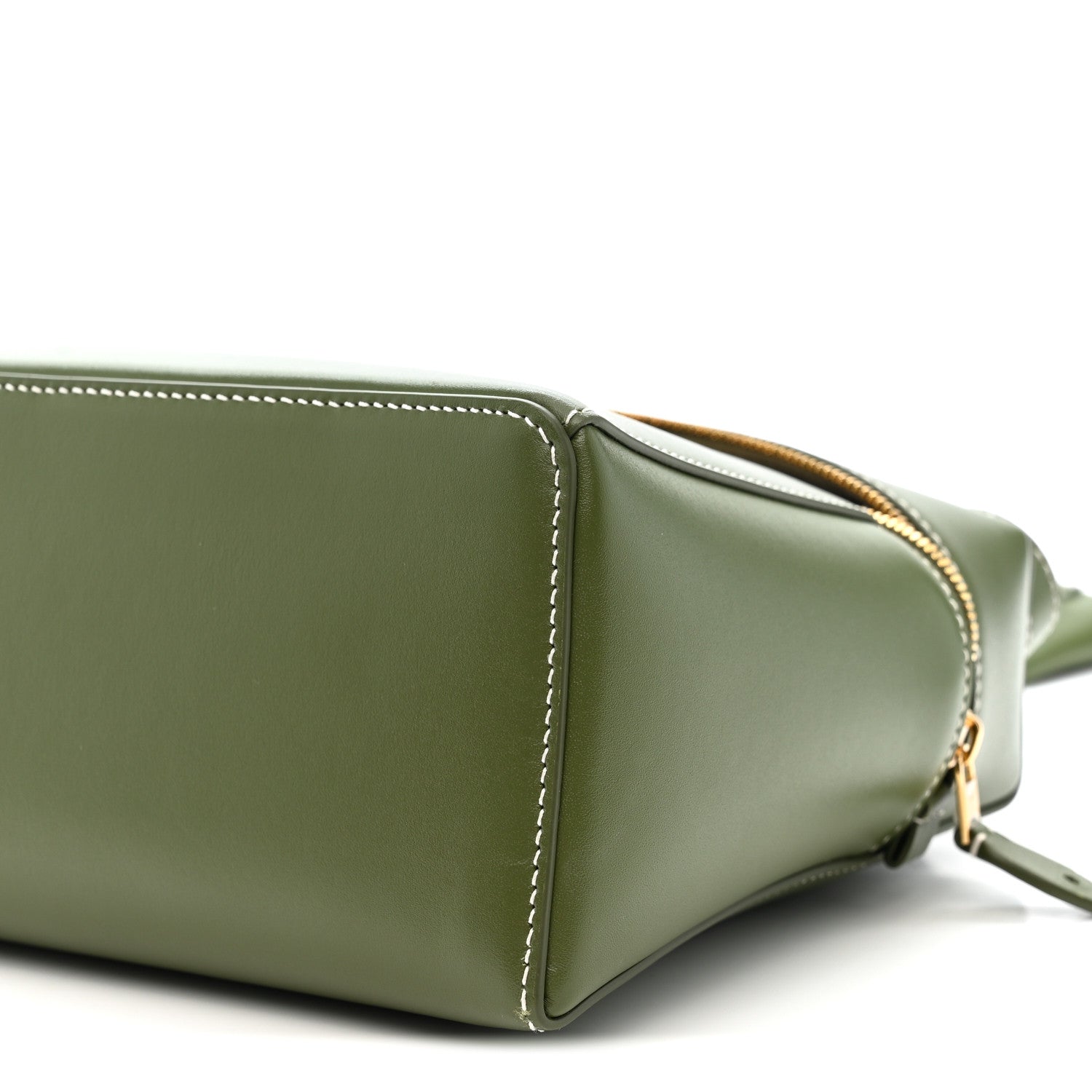 Olive green leather handbag corner detail with gold zipper trim and strap hardware