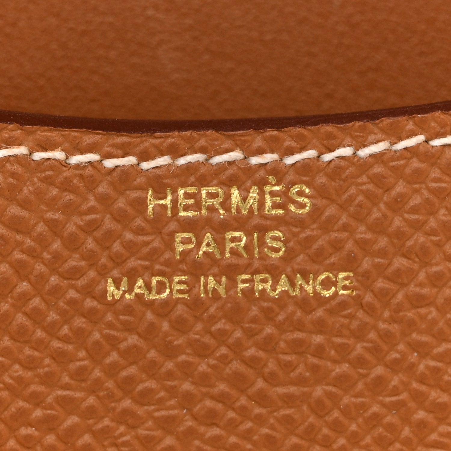 Hermes Paris made in France stamped on brown textured leather wallet.