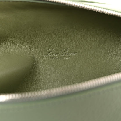 Embossed Loro Piana mark on sage green leather lining, close-up