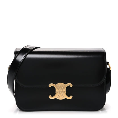 Shiny calfskin medium shoulder bag in black with gold Triomphe logo and shoulder strap