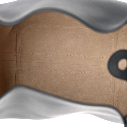 Tan leather interior lining with stitched seams and curved upper edge