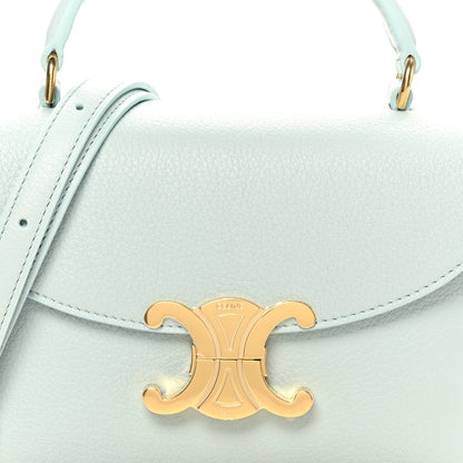 Light blue leather mini bag front with gold logo clasp and top handles