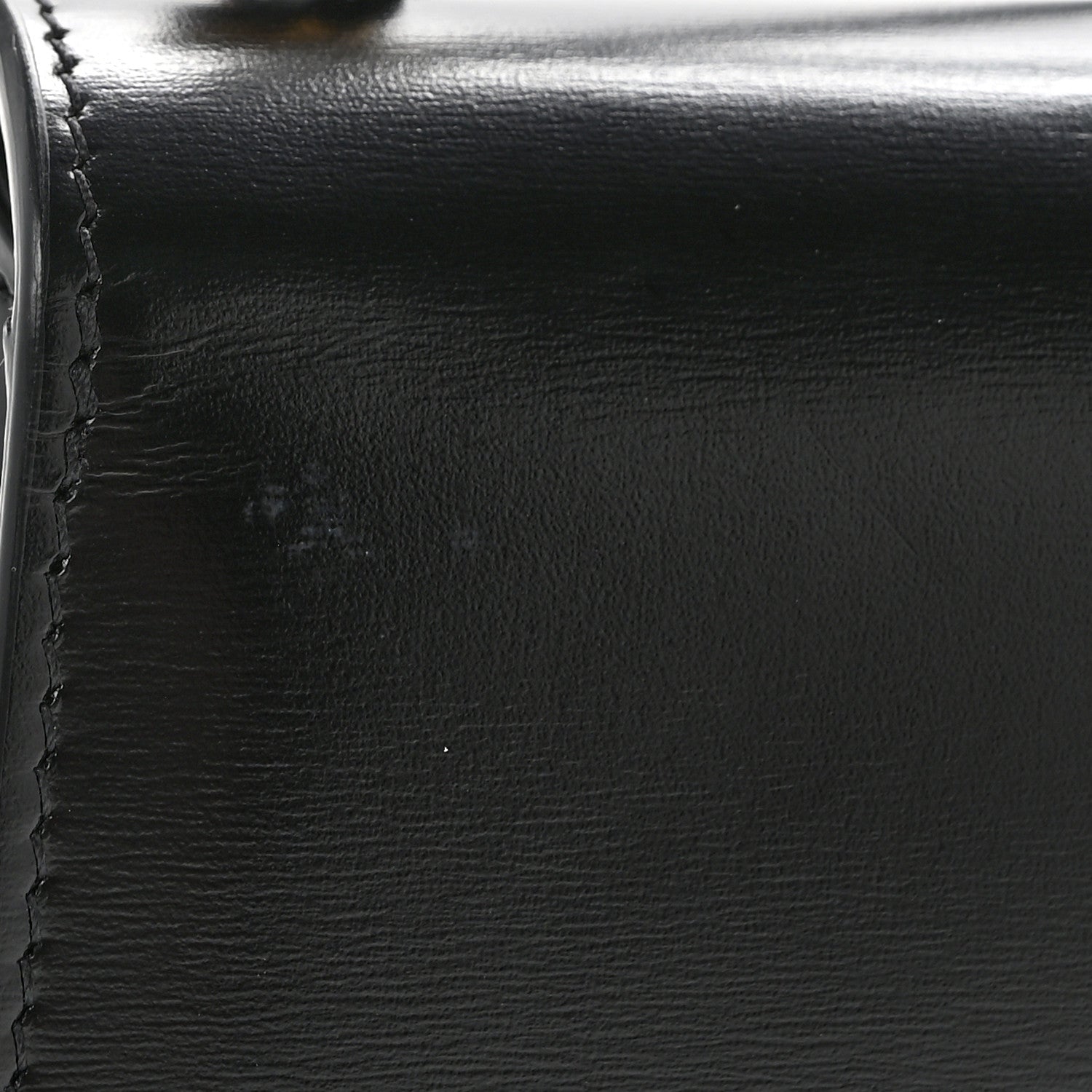 Black shiny calfskin with visible stitching and smooth edge close-up