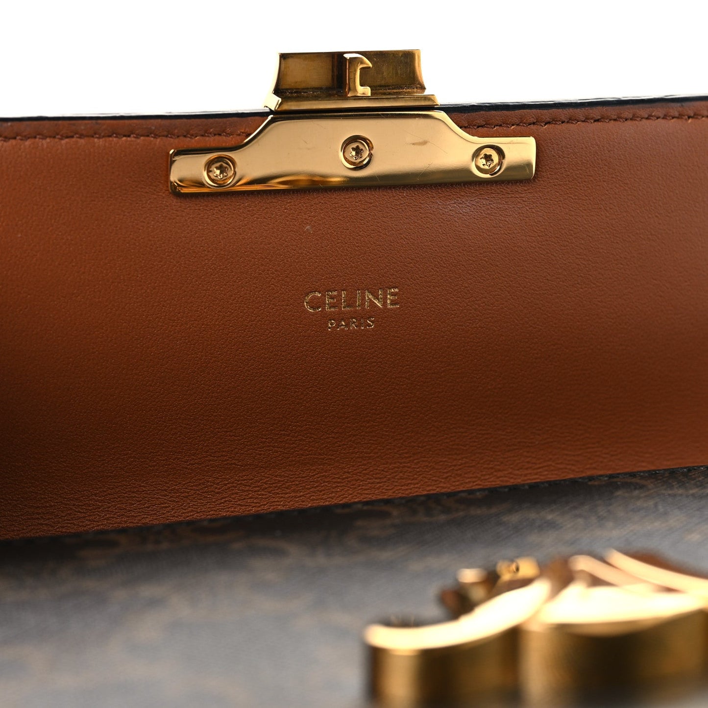 Celine bag clasp with gold hardware and brown leather lining panel