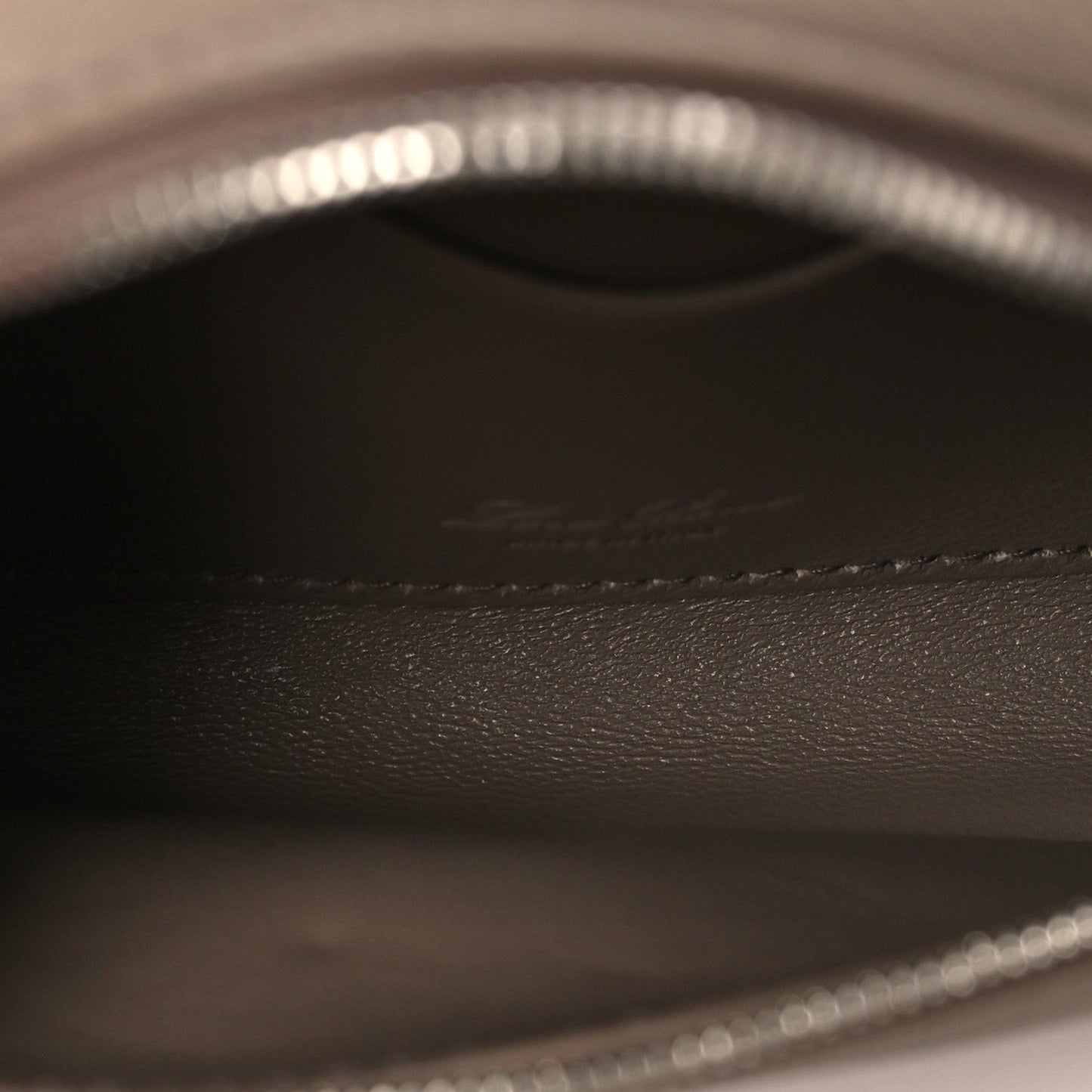 Leather interior lining with embossed logo and stitched trim