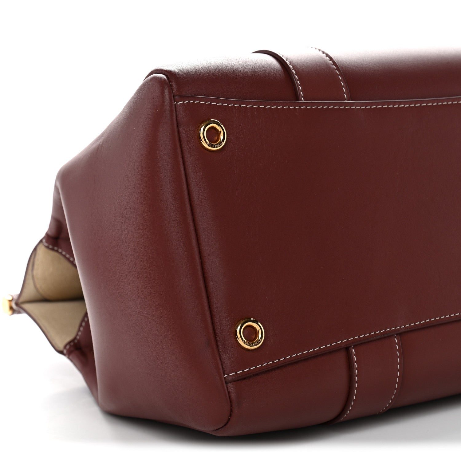 Calfskin bag corner with gold snap studs and stitched flap edge, dark brown