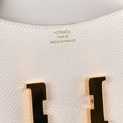 Pale gray leather with embossed “HERMES PARIS MADE IN FRANCE” near gold clasp.