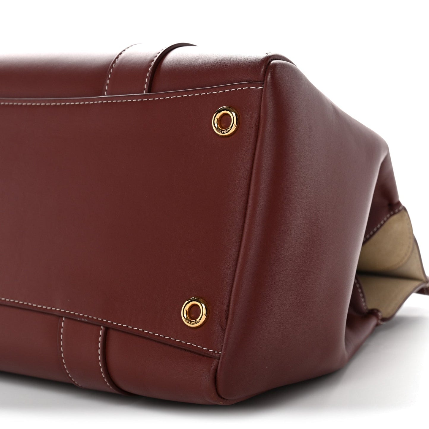 Calfskin loom bag end view with gold snap studs, dark brown, side pocket panel