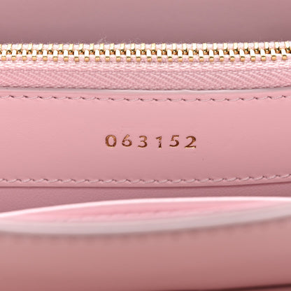 Pastel pink mini bag interior with gold zipper and stamped code 063152
