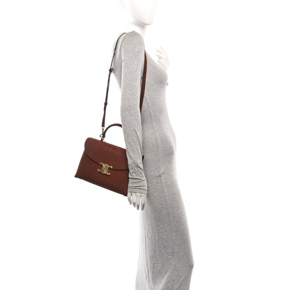 Chestnut brown leather satchel with shoulder strap and Celine logo emblem.