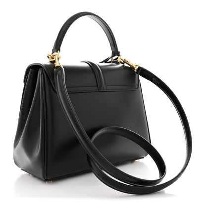 Black small top-handle satchel with long crossbody strap and gold-tone hardware