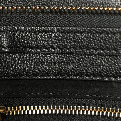 Black grained leather with “MADE IN ITALY” stamp and gold zipper trim