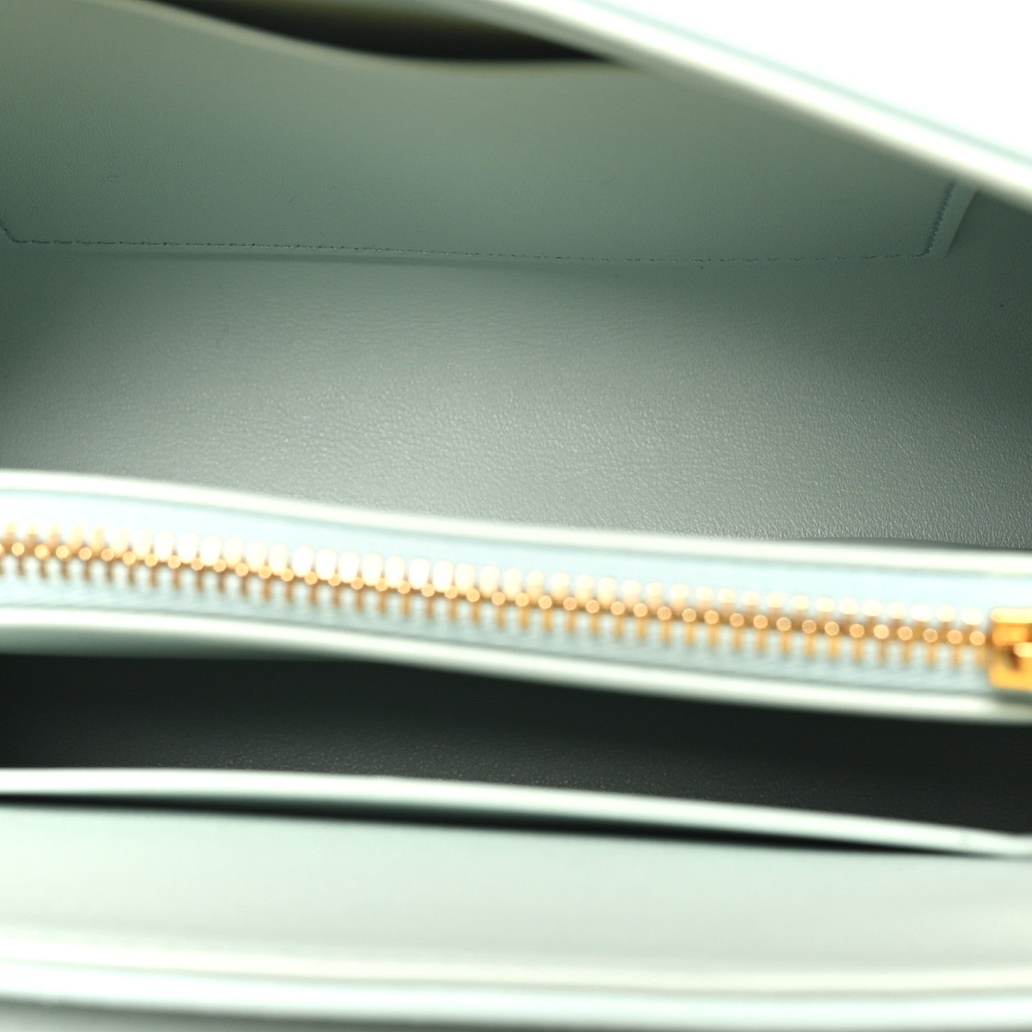 Leather lining with gold zipper track and pull tab