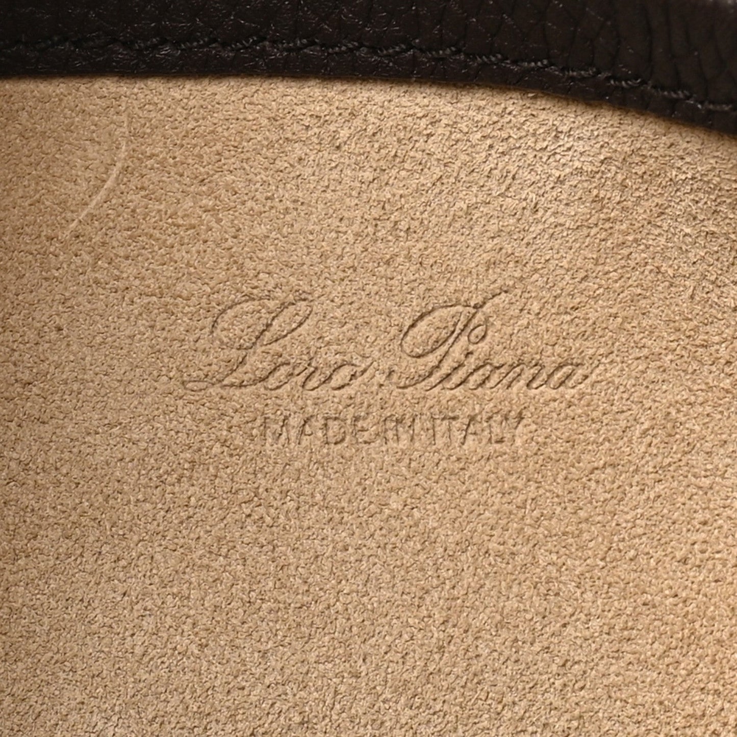 Loro Piana stamp on tan interior lining of a dark brown calfskin small bale bag