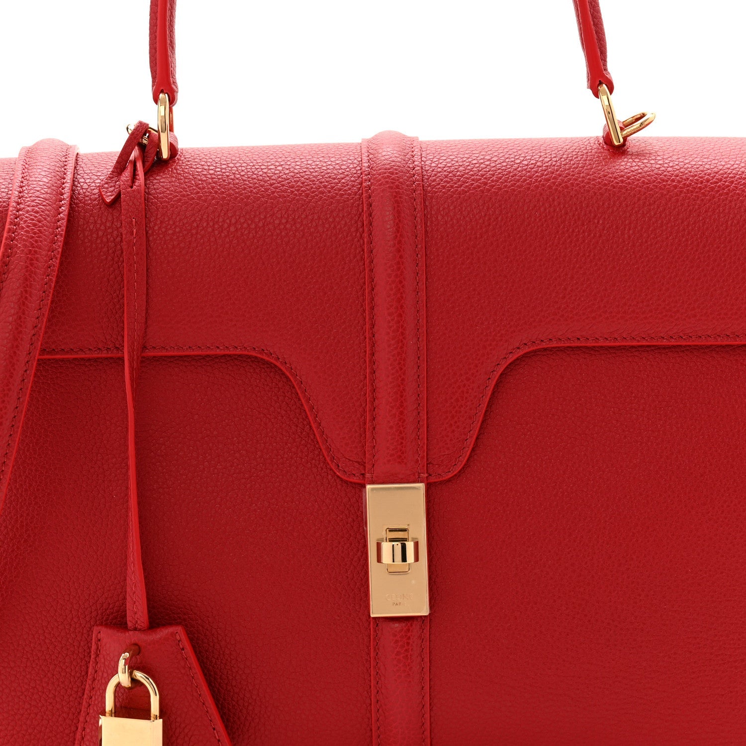 Red grained leather flap top with gold clasp and side pull tab