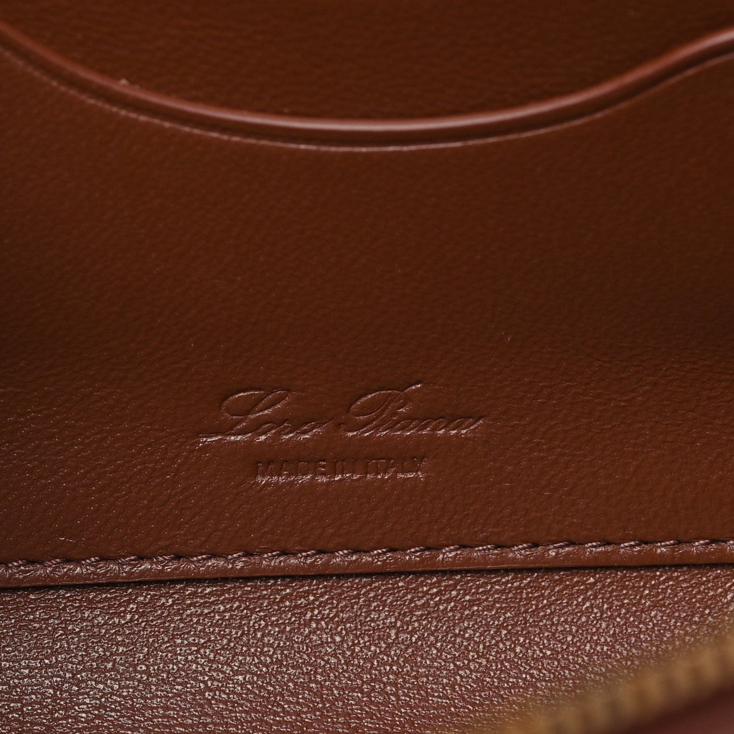 Loro Piana smooth calfskin clutch with embossed logo on burnt tan leather