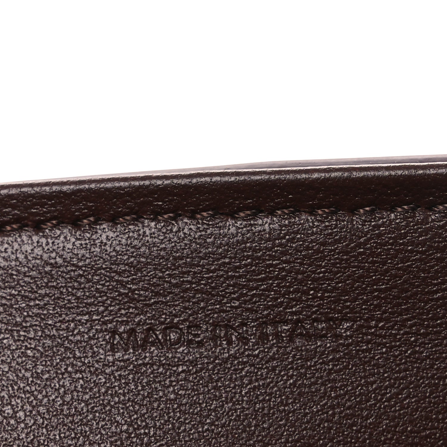 Leather edge seam with 'MADE IN' stamp.
