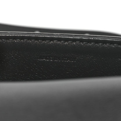 Close-up of black leather strap and grey snakeskin edge stitching
