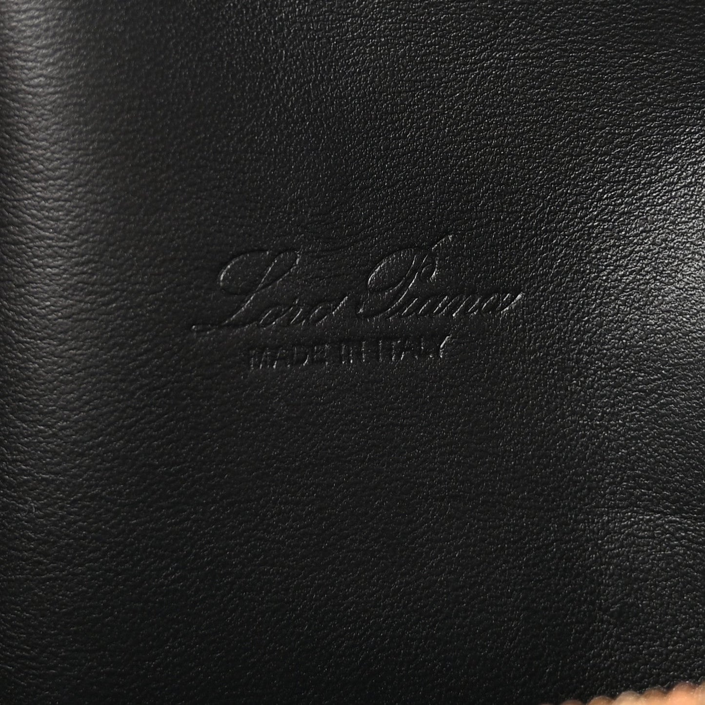 Loro Piana embossed logo on black grained calfskin pouch