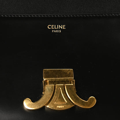 Celine Paris Triomphe gold-tone clasp detail on black leather flap