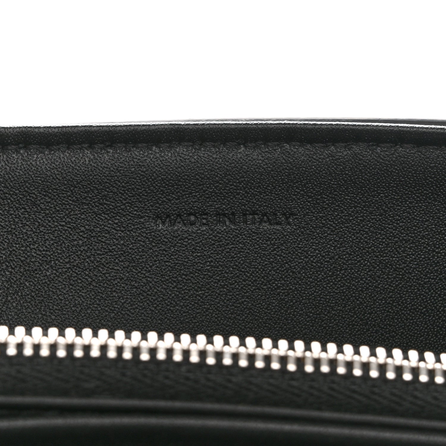Black leather bag with silver zipper teeth along the top opening