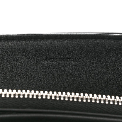 Black leather bag with silver zipper teeth along the top opening