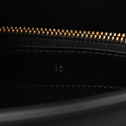 Celine mini bag close-up of beaded zipper and “16” stamp on black leather
