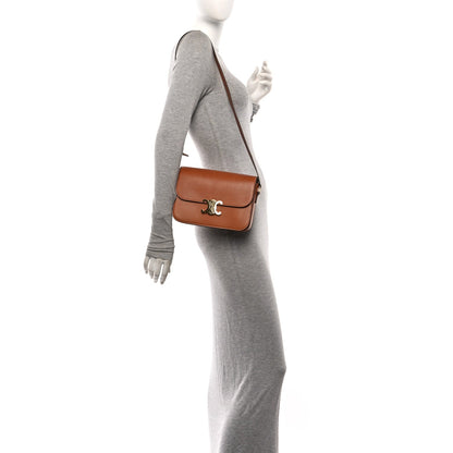 Celine tan crossbody shoulder bag worn on model with adjustable leather strap.