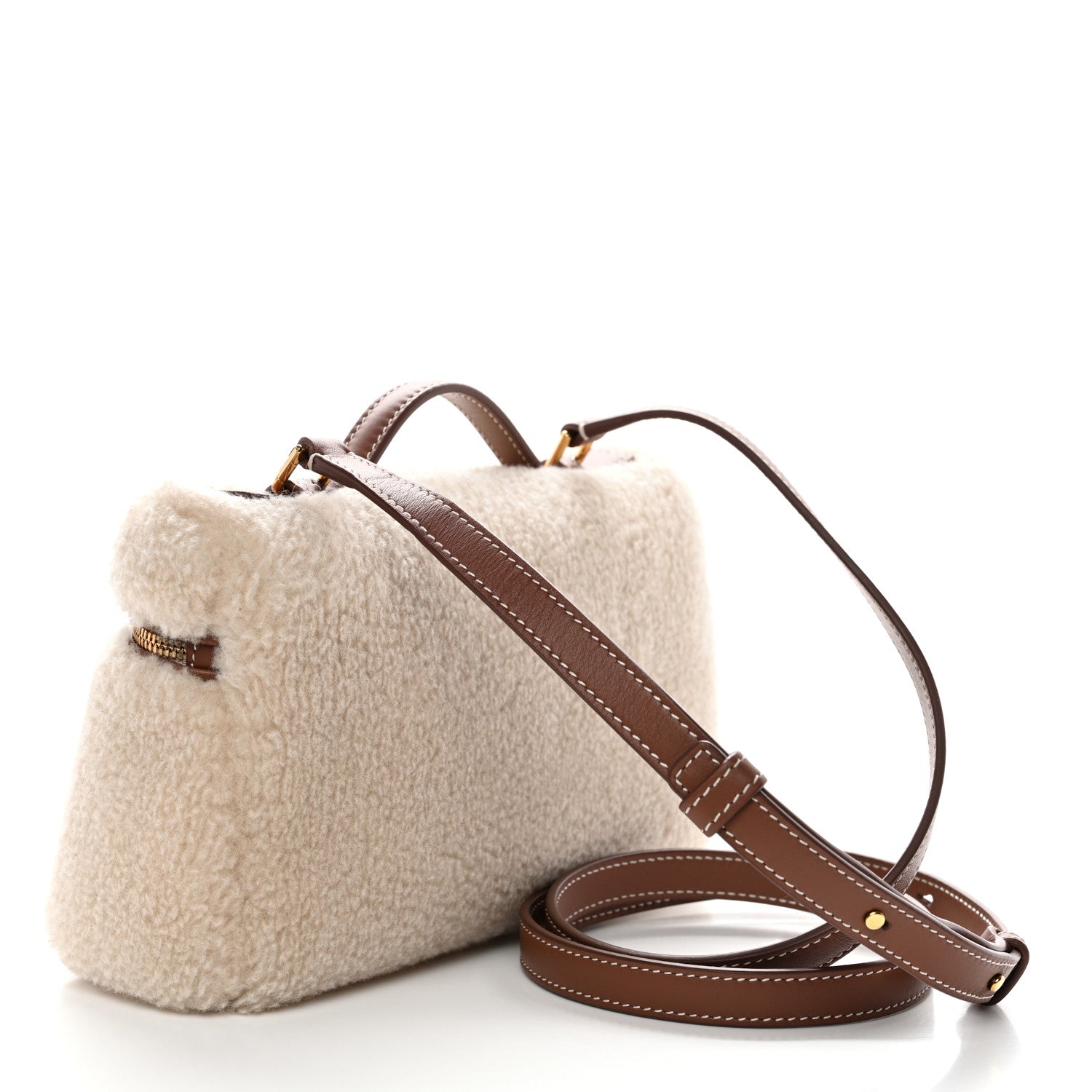 Cream faux-fur pouch with brown leather crossbody strap and gold top zipper
