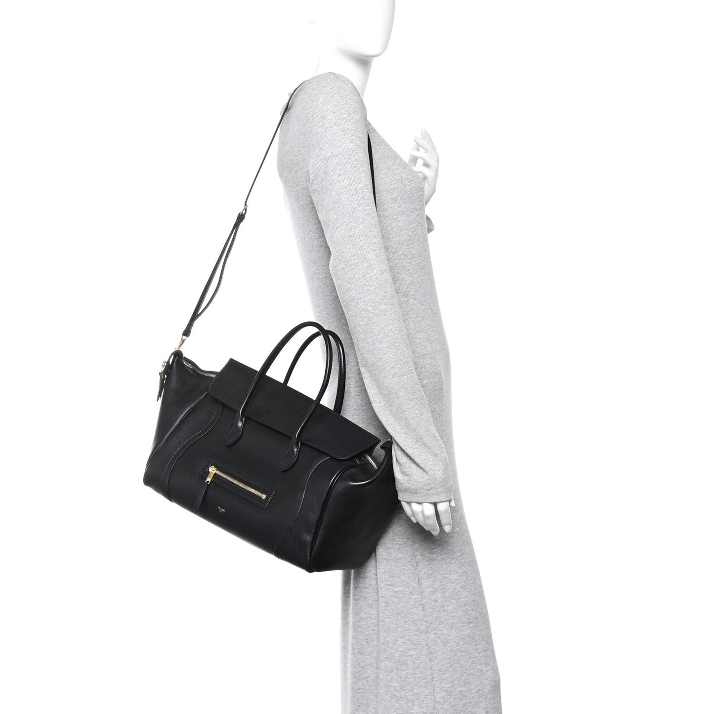 Black leather luggage bag with shoulder strap and front zip pocket.